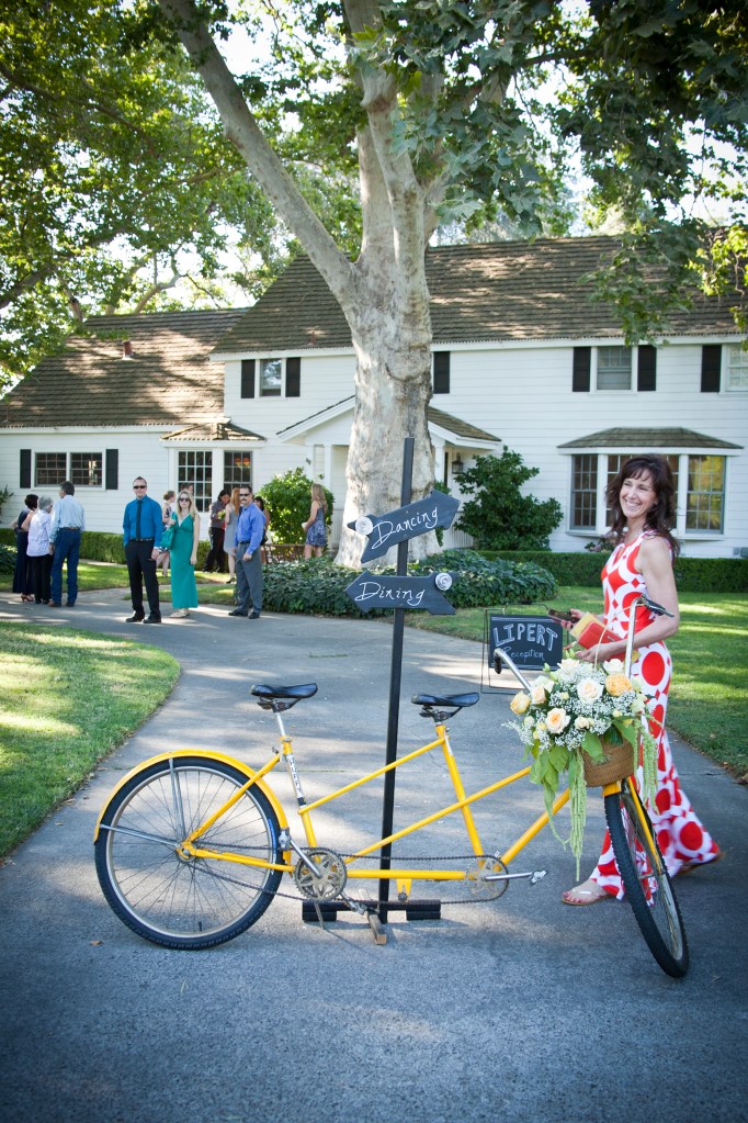 My sister, Cathy posing with the darling bicycle built for two. The Bride and Groom later left on this bike, cutest thing ever.
