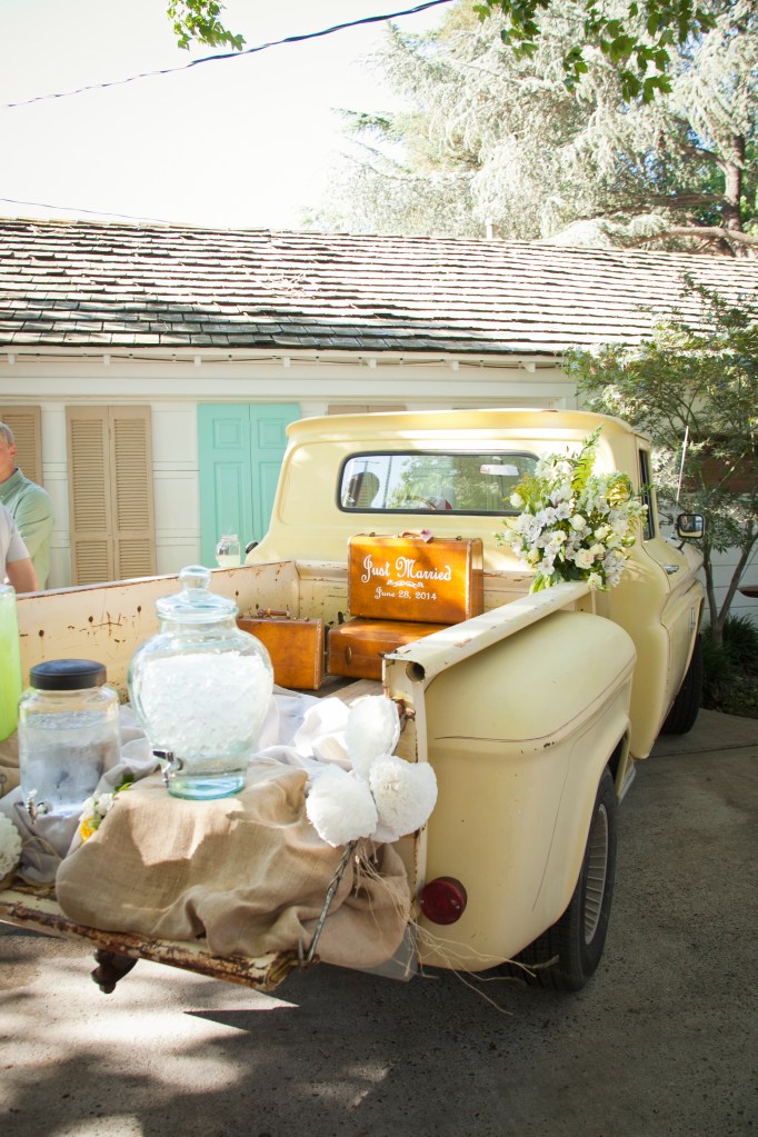 Water and lemonade was served from the tailgate of this 50's pick-up. I die… and the suitcase? what? so cute