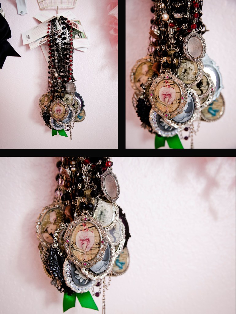 Hanging on the wall is a collection of necklaces Mallory made. I personally have one of these and I love it. They are so special and handmade with antique papers. These are one of a kind pieces you can only get from Mallory. Let's take a look at some of her favorites,