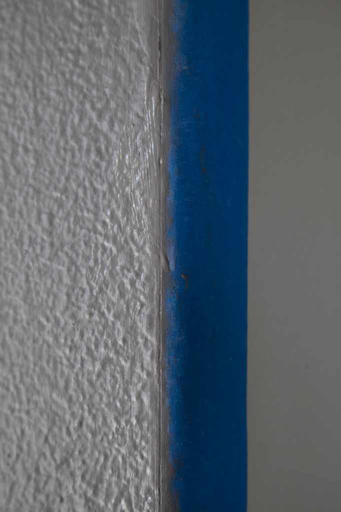 This has the caulking over it. The seam should look sealed on the edged.