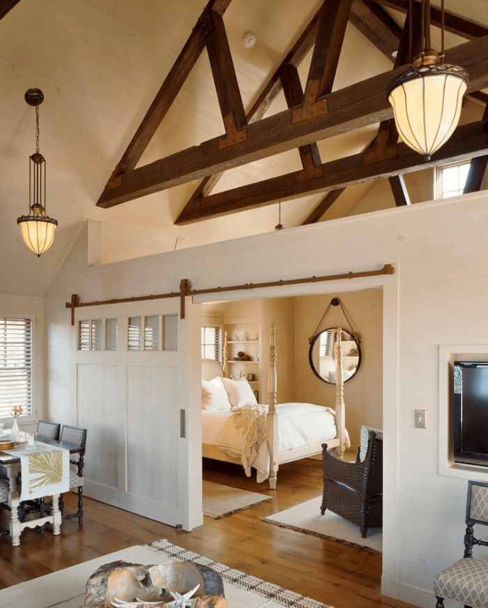 Here is a perfect example of closing off a whole room. This darling little loft apartment is made more private with the addition of a farm door.