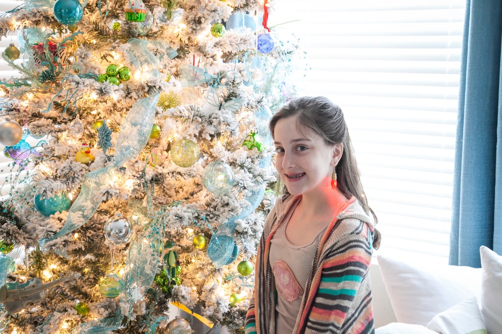 Miss Emma, putting on a nice pose in front of the tree. How much do you love her flashing bulb earrings?!