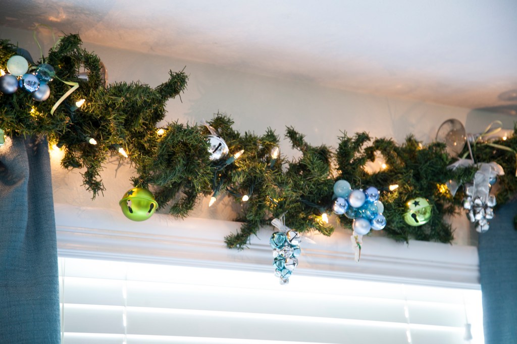 Next to the tree is our Jingle bell garland. Can you guess why we call it that? Many of these bells are from packages and things we've gotten as gifts. Every new bell goes here.