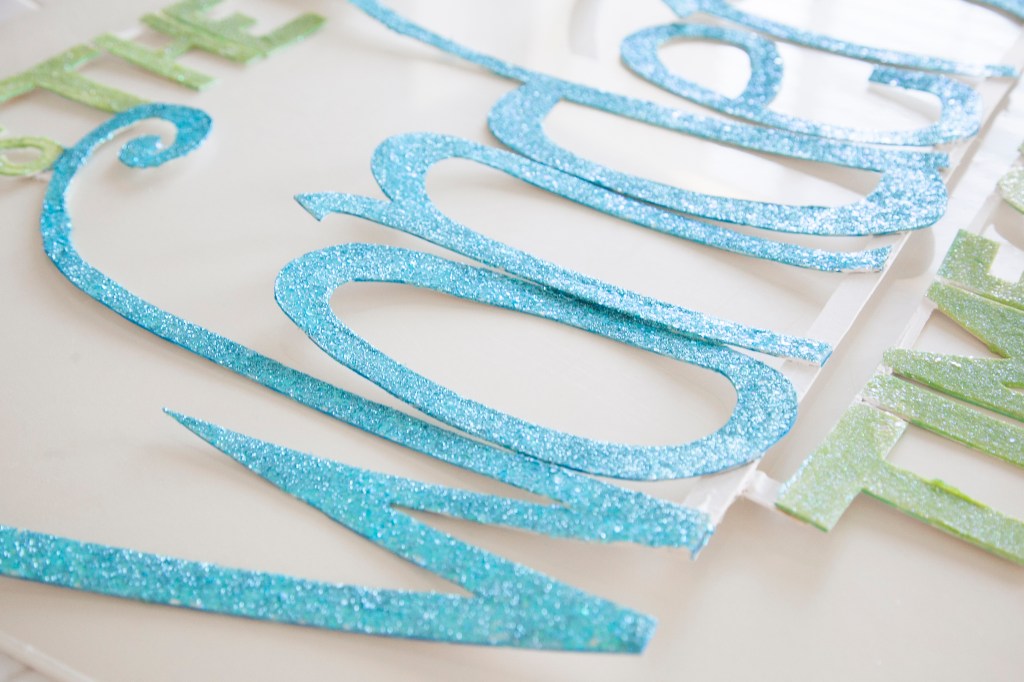 My sister, Korbi and I glittered the sign over Christmas but realized we needed to do it again. Then after the second glittering I realized I needed to color the edges of each letter with ink pen. I didn't like the light mat board showing along the edges. 