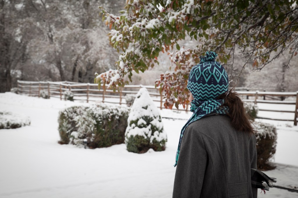 Emma was so excited, she didn't even bother getting dressed. she just threw on her coat, had and scarf.