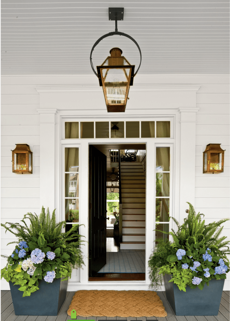 Fabulous door! I love the little windows along the side of the door. The plants add a nice touch and the lantern, Love!