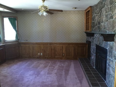 This is what the den looked like when we bought the house. Pink carpet and beautiful wood paneling. We would have left the wood, as it's solid oak and in beautiful shape, however, in order to build up the floor we had to remove it. Not a single piece was broken during removal. You'll be seeing it again! 